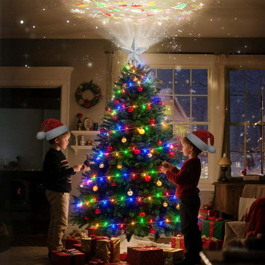 Two children in Santa hats decorating a Christmas tree in a cozy living room.